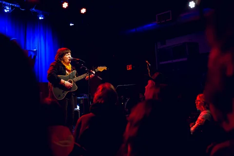 Guitarist on stage, seen from the audience at the 2025 Jason Molina MusiCares benefit.