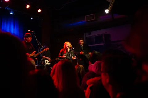 Singer and band performing beyond the audience at the 2025 Jason Molina MusiCares benefit.