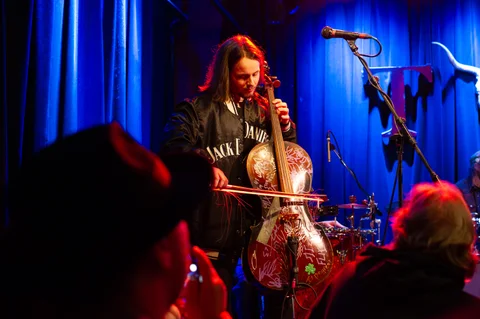 Cellist performing on stage at the 2025 Jason Molina MusiCares benefit.