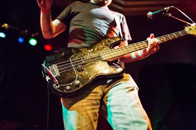 Close-up of a bass guitar during the performance. The Trouble Starts, East release show, August 16, 2013.